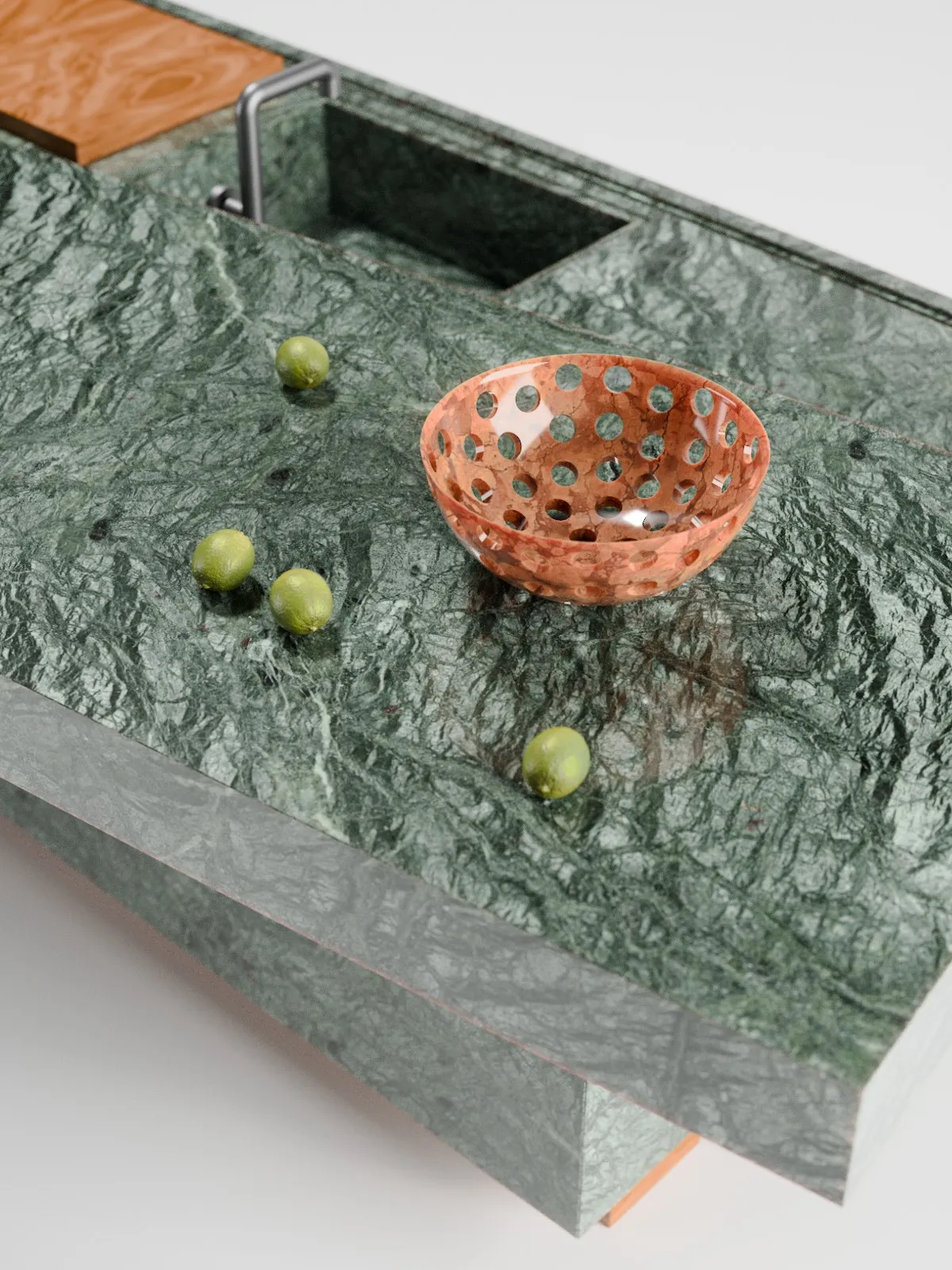 A terracotta-veined perforated marble bowl resting on a green marble surface with limes.